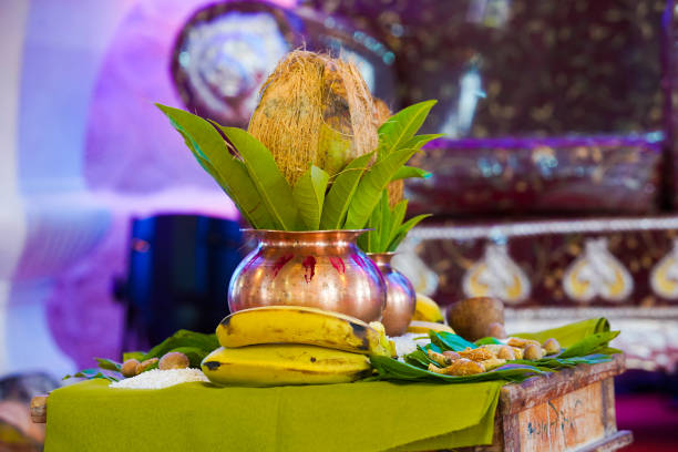 Indian wedding ceremony : decorative coper kalash with green leaf and coconut