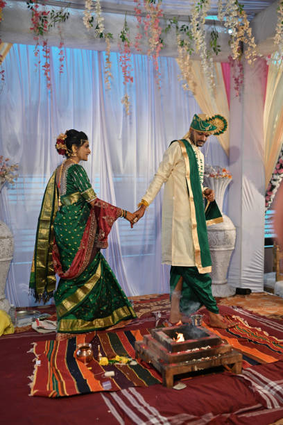 In this traditional Hindu wedding ceremony, the bride & groom take seven full circles, hand in hand around a sacred fire representing the promises and principles they make to each other. Each step symbolizes their commitment and love for each other. By encircling the flames, they seek blessings for their union, promising to support and cherish each other for a lifetime.